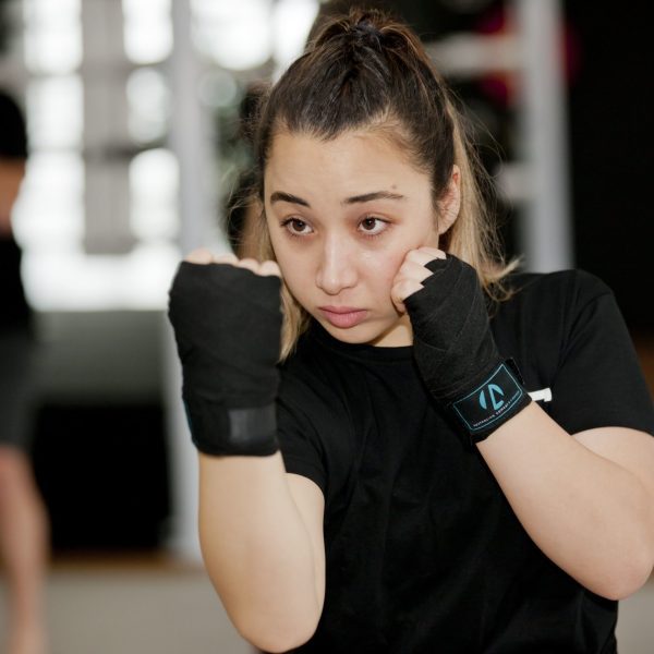 A female boxing student learning to punch